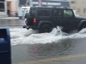 Rain, hail and lightning prompt flood advisories, force beach closures across SoCal